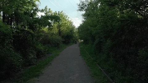 Old railroad track turned into a pathway for walkers and bikers Stock Footage 125288401