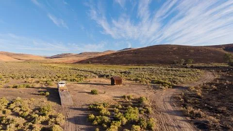 Old ranch structure adjacent to a wildfire scar Stock Photos
