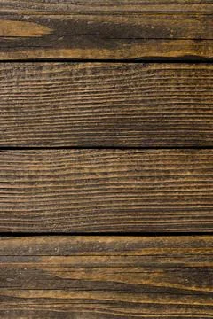 Old, raw boards arranged in a row. Stock Photos