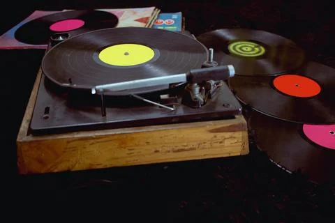 An old record player next to some vinyl records Stock Photos
