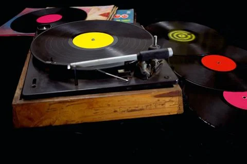 An old record player next to some vinyl records Stock Photos