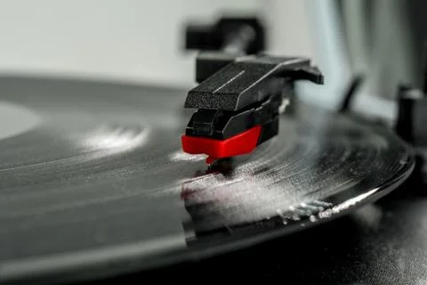 Old record player stylus on a rotating disc, vintage. Stock Photos
