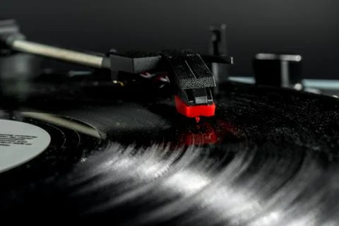 Old record player stylus on a rotating disc, vintage. Stock Photos