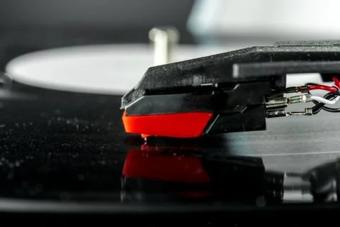 Old record player stylus on a rotating disc, vintage. Stock Photos