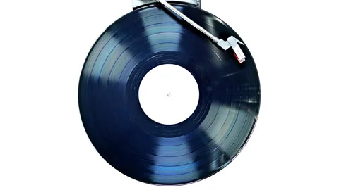 An old record spinning on a turntable isolated on white Video stock 118676896
