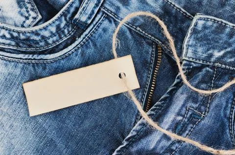 Old rectangular clean paper and brown rope on blue jeans Stock Photos