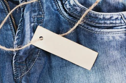 Old rectangular clean paper and brown rope on blue jeans Stock Photos