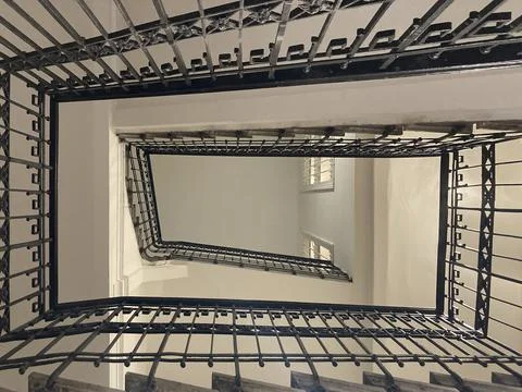 Old rectangular spiraling winding staircase in an building Stock Photos