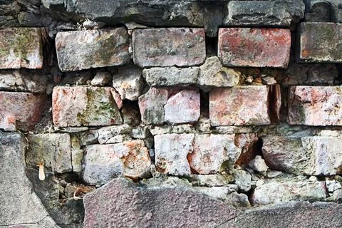 Old red and grey brick wall texture with cracks and weathered surface Stock Photos