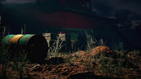 Old red boat stranded in desert landscape at night, with scattered debris Stock Footage 318320940