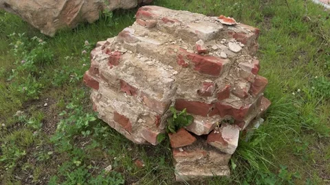Old red brick and concrete foundation ruins on green grass 스톡 동영상 344041642