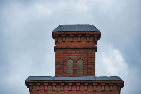 Old Red Brick Architectural Chimney Tower Detail Against Sky Stock Photos