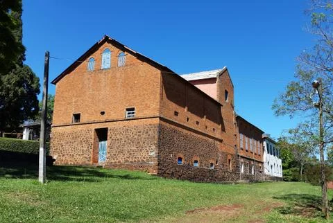 An old red brick barn set in the rural countryside of Brazil region. Stock Photos