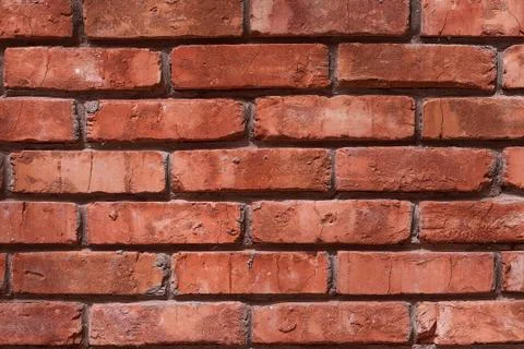 Old red brick brick wall with glare from the sun Stock-Fotos