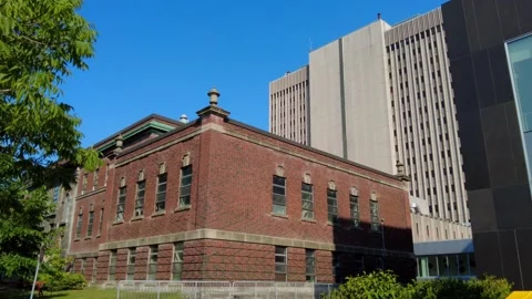 Old red brick building among new skyscrapers 動画素材 314734427