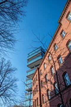 Old red brick building in front of architectural modern office building and b Stock Photos