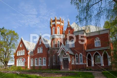 Old red brick castle at sunny day. Latvia. Stock Photos