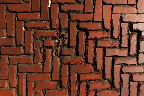 Old red brick paver texture in herringbone pattern weathered pavement background Stock Photos