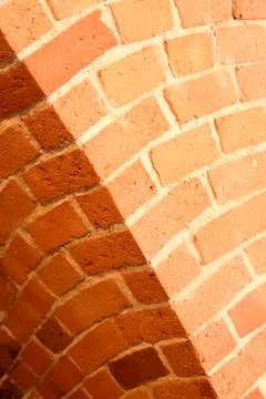 Old red brick wall with an arc background Stock Photos