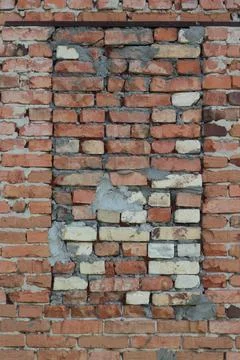 Old Red Brick Wall with Brick Up Window Opening Texture Close Up Stock Photos