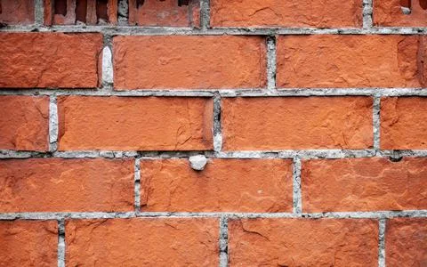 Old red brick wall. The bricks are laid in rows. Grunge stone texture. 写真素材