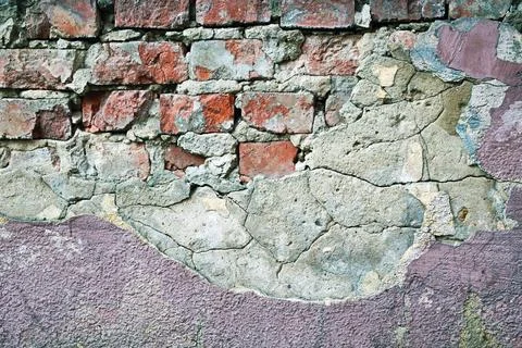 Old red brick wall with crumbling plaster and cracked cement texture Stock Photos