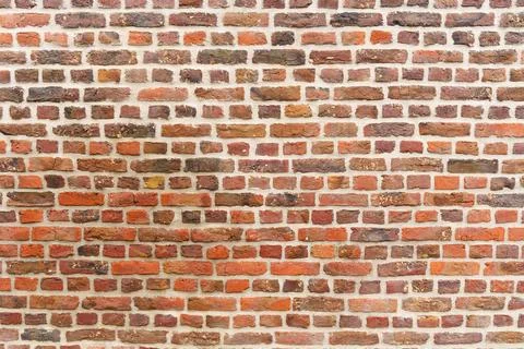 Old red brick wall with different shades. Texture of a brick wall Foto stock