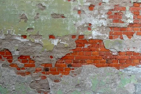 Old red brick wall with falling concrete plaster Stock Photos