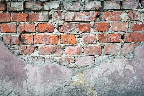 Old red brick wall with peeling plaster and cracked concrete surface texture Stock Photos
