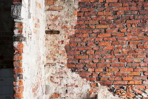 An old red brick wall with remnants of white plaster. Vintage background Stock Photos