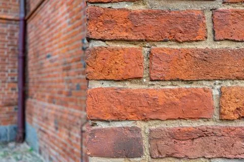 An old red brick wall with a rough cement seam Stock Photos