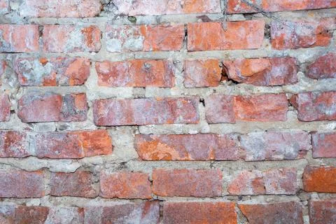 Old red brick wall with rough texture and weathered surface for background Stock Photos