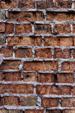 Old red brick wall, rustic, shattered texture, design vertical background. Stock Photos