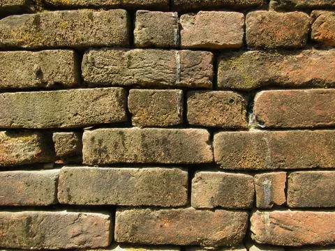 Old red brick wall texture background with moss and dirt Stock Photos