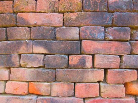 Old red brick wall texture background with moss and dirt Stock Photos