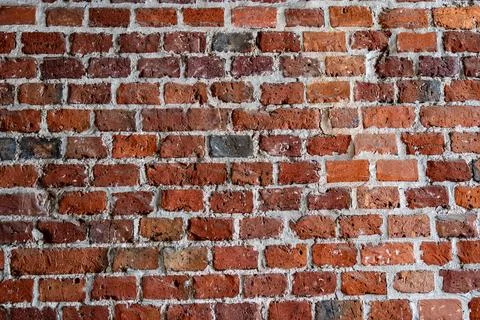 Old red brick wall texture with weathered surface. Stock Photos