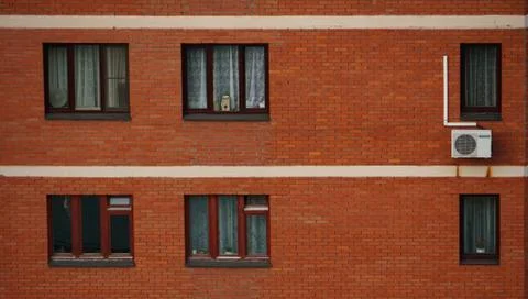 Old red brick wall with windows in Moscow. Urbain background 스톡 사진