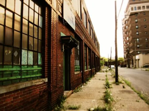 Old red brick warehouse in a decaying city Stock Photos
