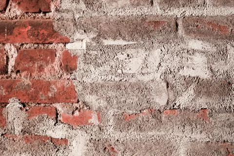 Old red bricks wall with white plaster. Rough, damaged surface, loft style. V Stock Photos