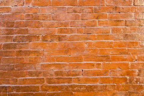 Old red brickwork with cracks. rough surface texture. brick wall Foto stock