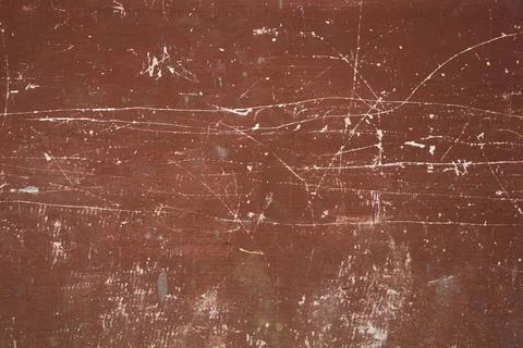 Old red-brown wall with deep white scratches and stains. rough texture. Stock Photos