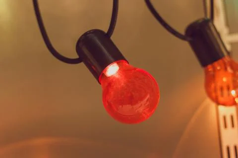 Old red bulb hanging from the ceiling close-up Stock Photos