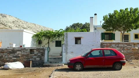 An old red car parked at the ancient white house. Stock Footage 197376699