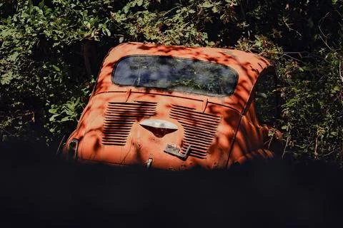An old red car with a rusty body Stock Photos