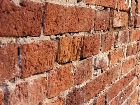 Old red colored brick wall abstract background Foto stock