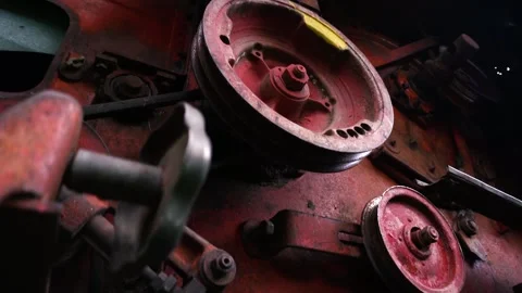 Old red combine harvester pulleys for moving Stock-Footage 335207166