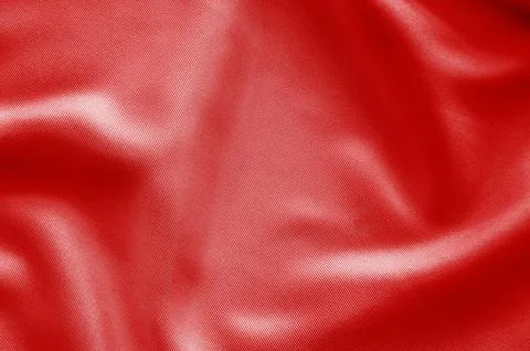 Old red fabric texture with dynamic folds creating a powerful abstract back.. Stock Photos