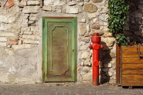 Old red fire hydrant in the street. Fire hidrant for emergency fire access Stock Photos