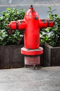 Old Red Fire Hydrant Water Pipe on Urban Sidewalk with Iron Chain and Weath.. Stock Photos