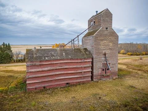 An old red grain elevator sits in a field Stock Photos